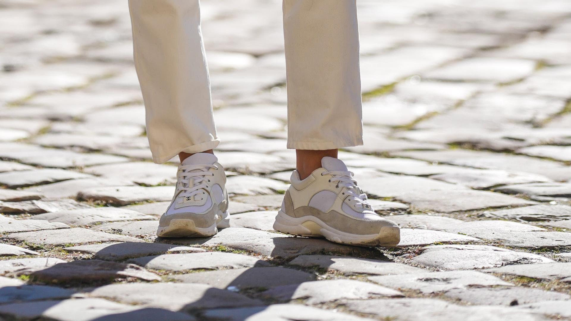 Frau trägt beige-weiße Sneaker mit Plateau-Sohle