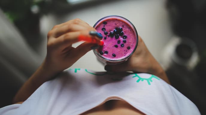 Frau hält Smoothie in der Hand