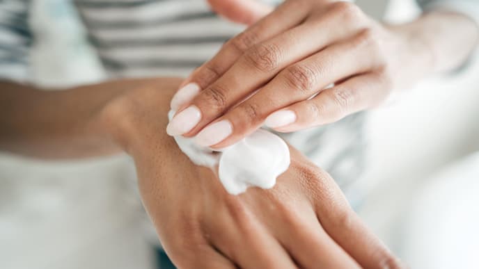 Handcreme auf Händen auftragen