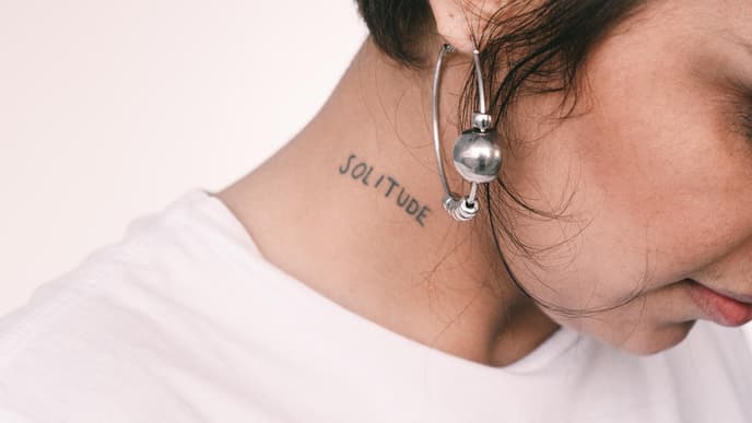 Frau mit einem Tattoo am Hals