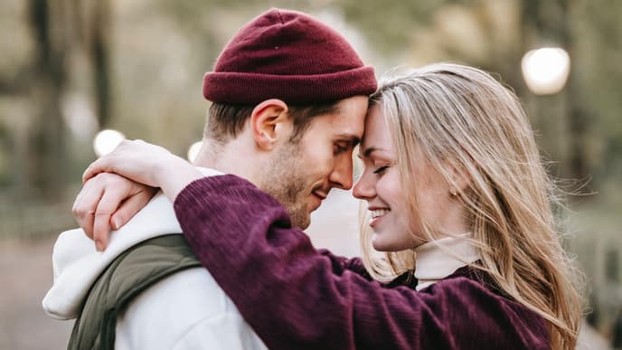 Bedingungslose Liebe: Frau und Mann umarmen sich, Stirn an Strin