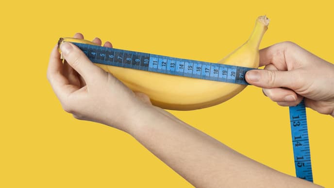 Penisgröße: Hände messen eine Banane mit einem Maßband aus