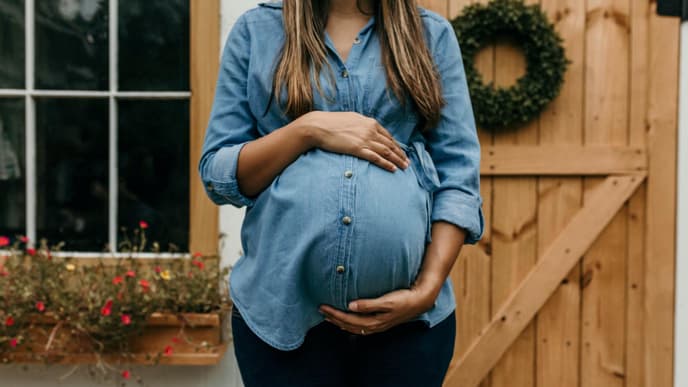 Schwangere Frau hält ihren Bauch