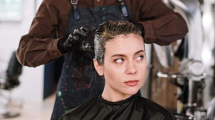 Frau bekommt ihre Haare gefaerbt