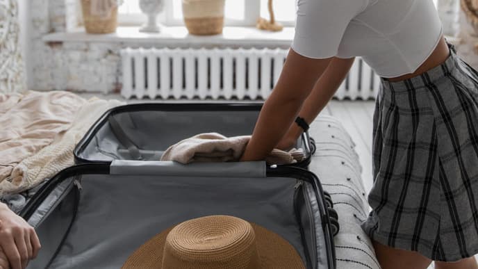 Frau packt ihren Koffer für den Urlaub