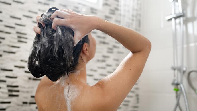 Frau wäscht Haare