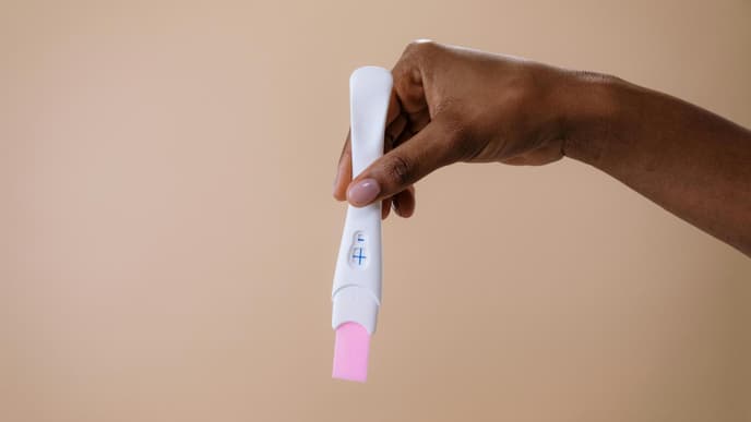 Person hält Schwangerschaftstest in der Hand