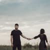 Frau und Mann halten sich an der Hand