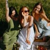 Horoskop: Drei Frauen auf Picknickdecke