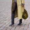 Kniehohe Stiefel kombinieren Frau trägt Stiefel in Grau mit Kitten Heel und spitzer Zehenpartie Ledermantel und Strumpfhose