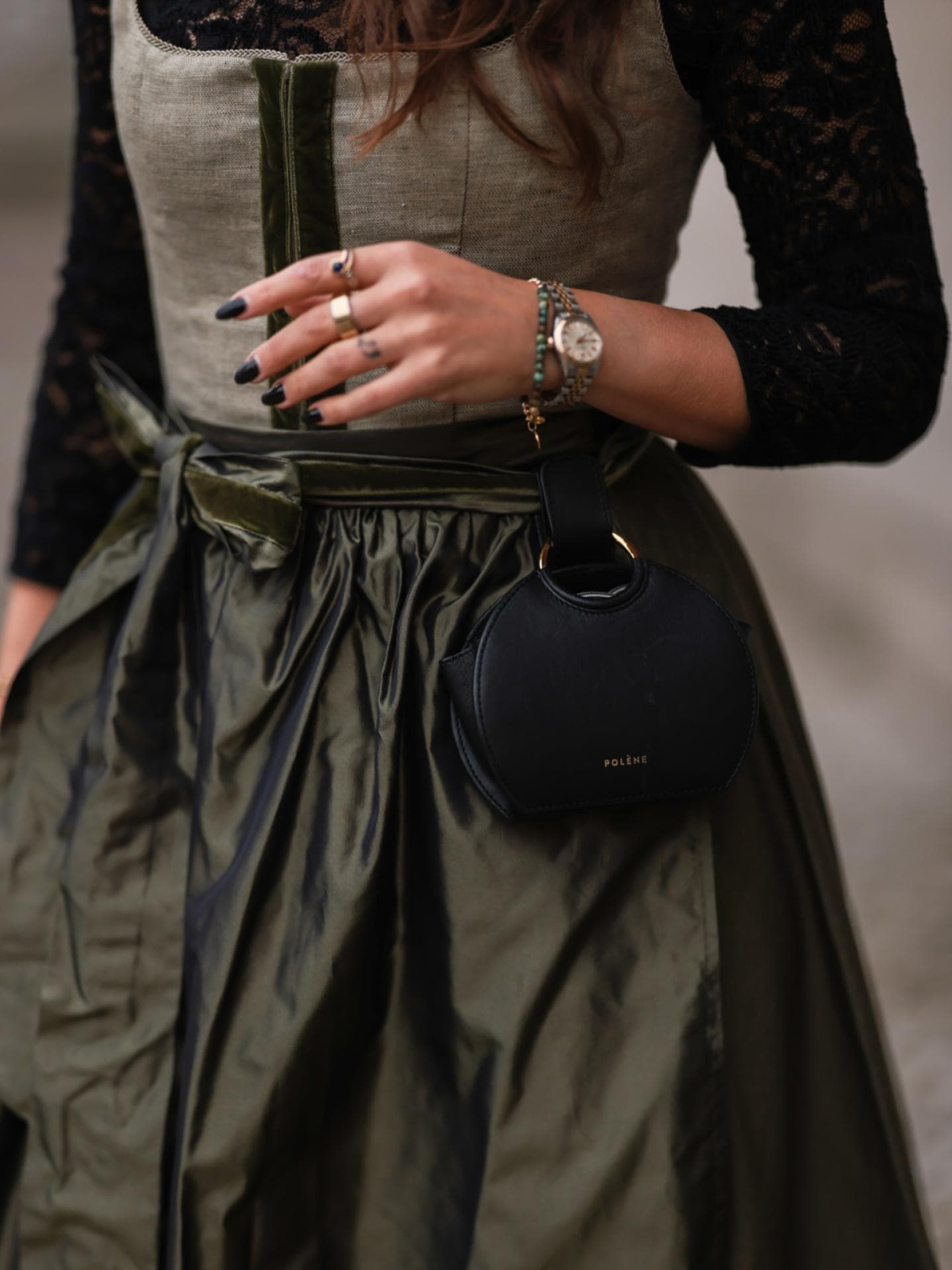 Eine Frau trägt eine Tasche zum Dirndl