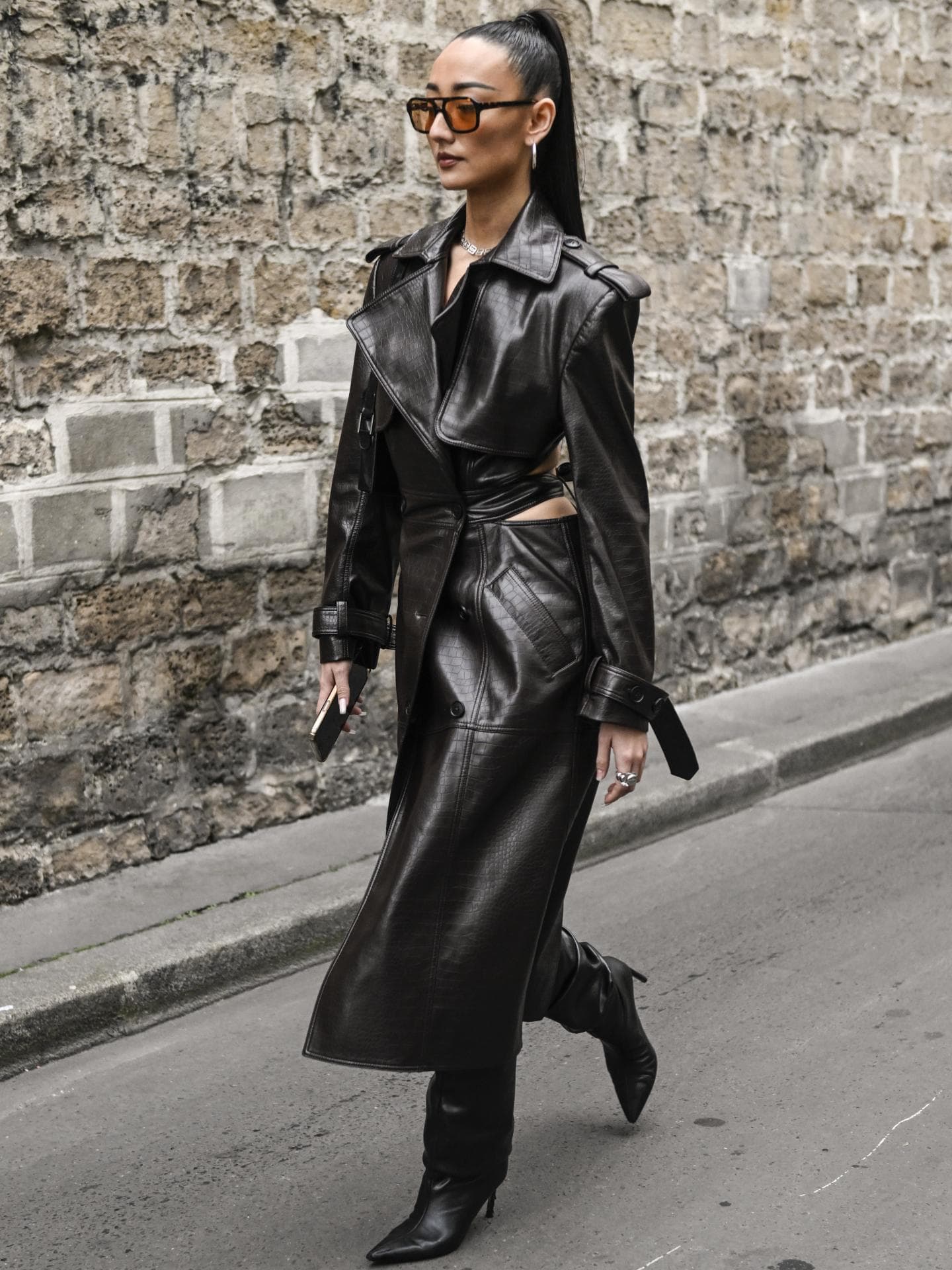 Frau trägt Ledertrenchcoat