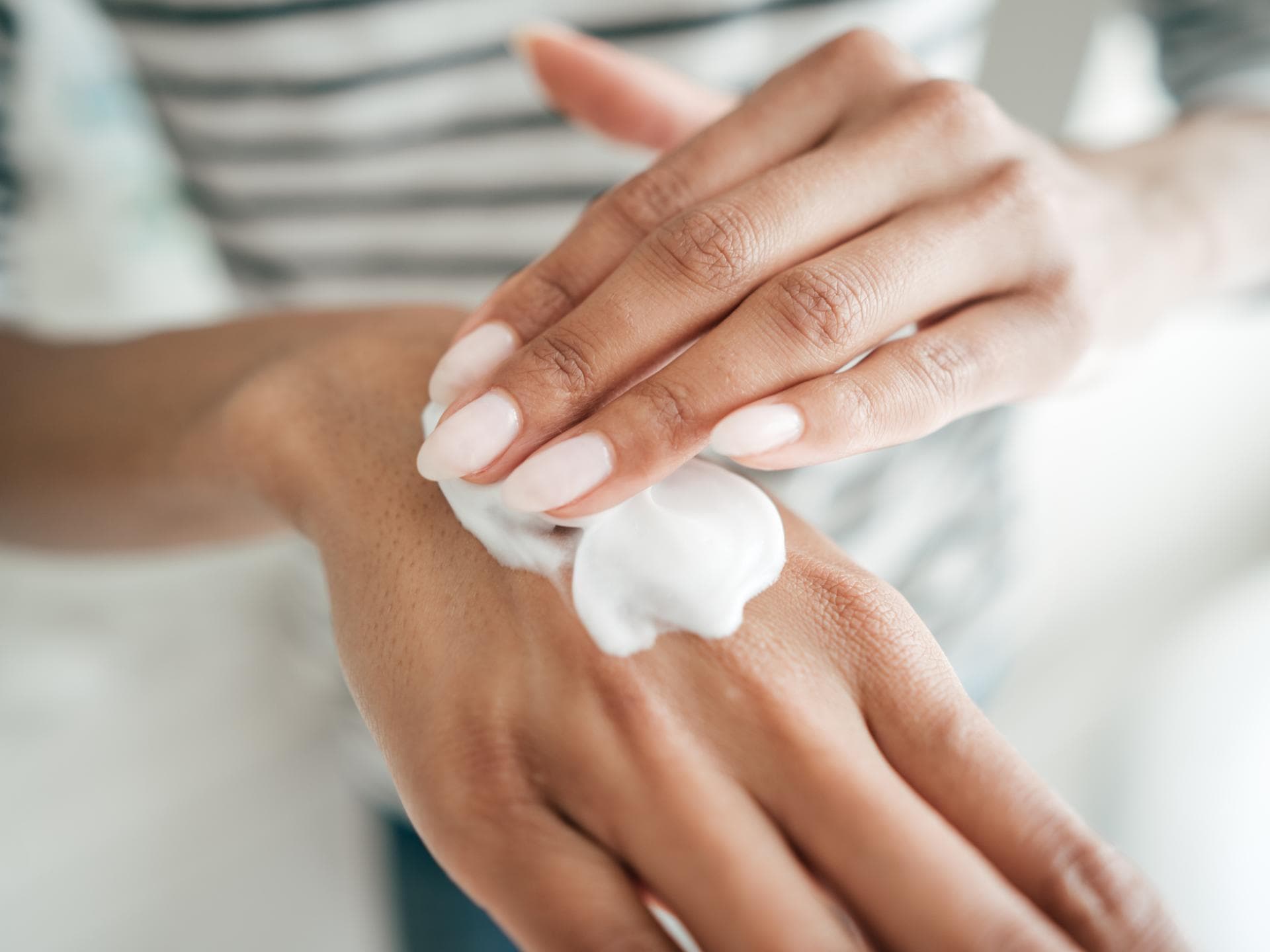 Handcreme auf Händen auftragen
