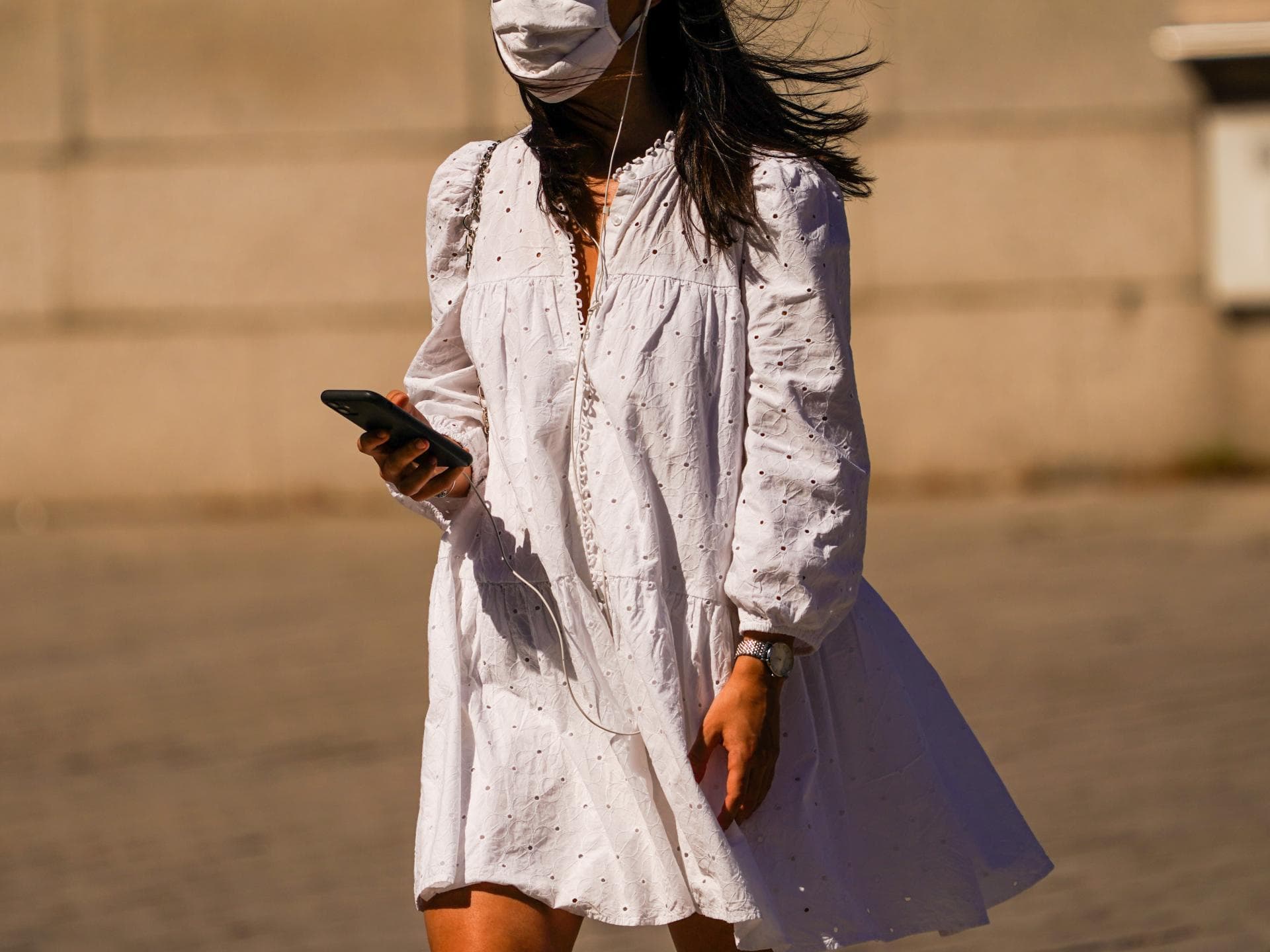 Frau im Sommerkleid mit Mund-Nasen-Schutzmaske