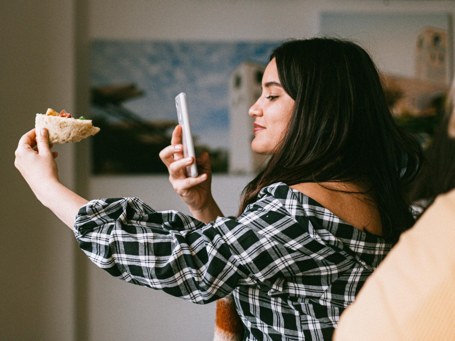 Mädchen fotografiert ihr Essen mit Smartphone