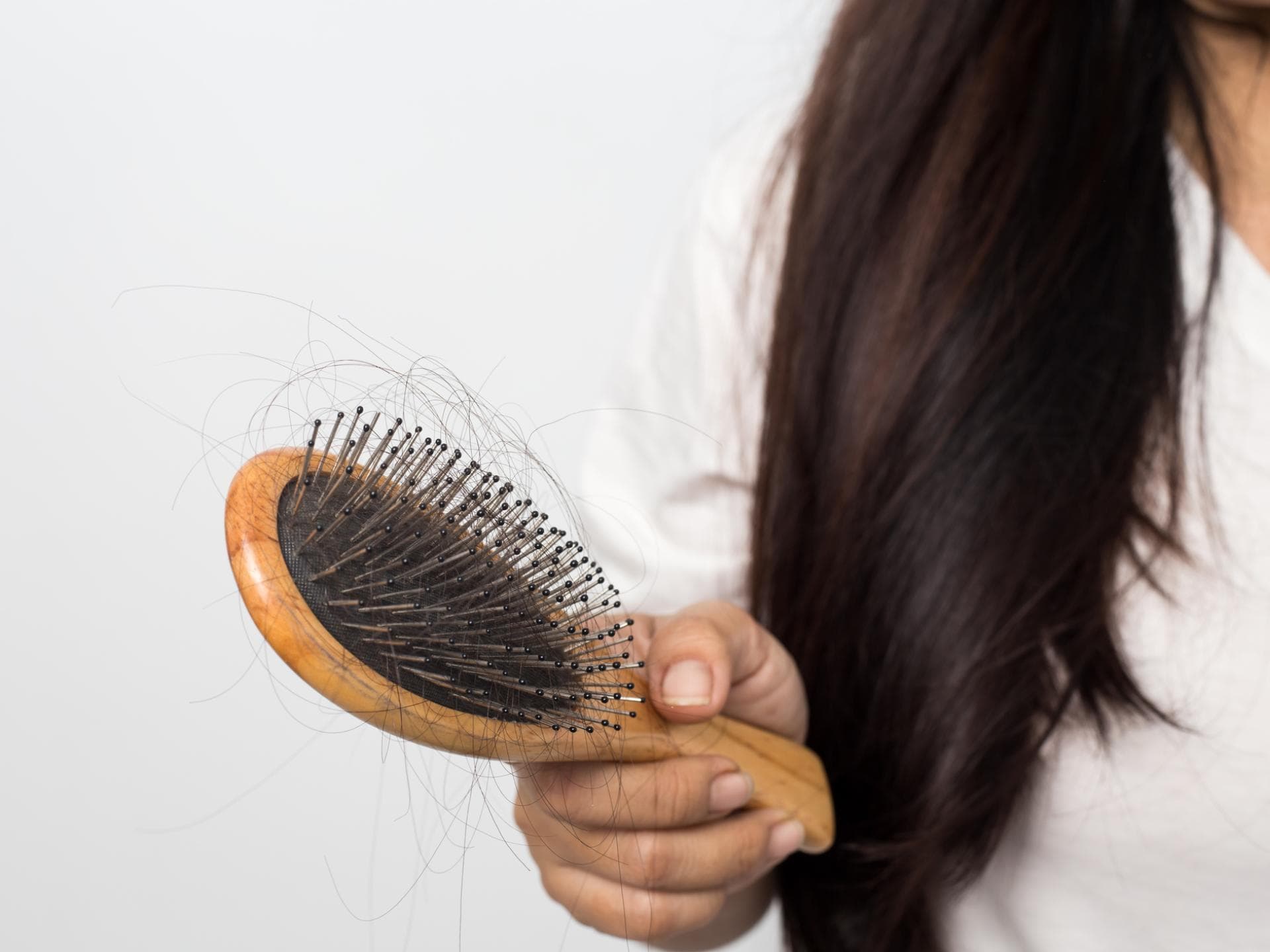 Frau hält Haarburste in der Hand 