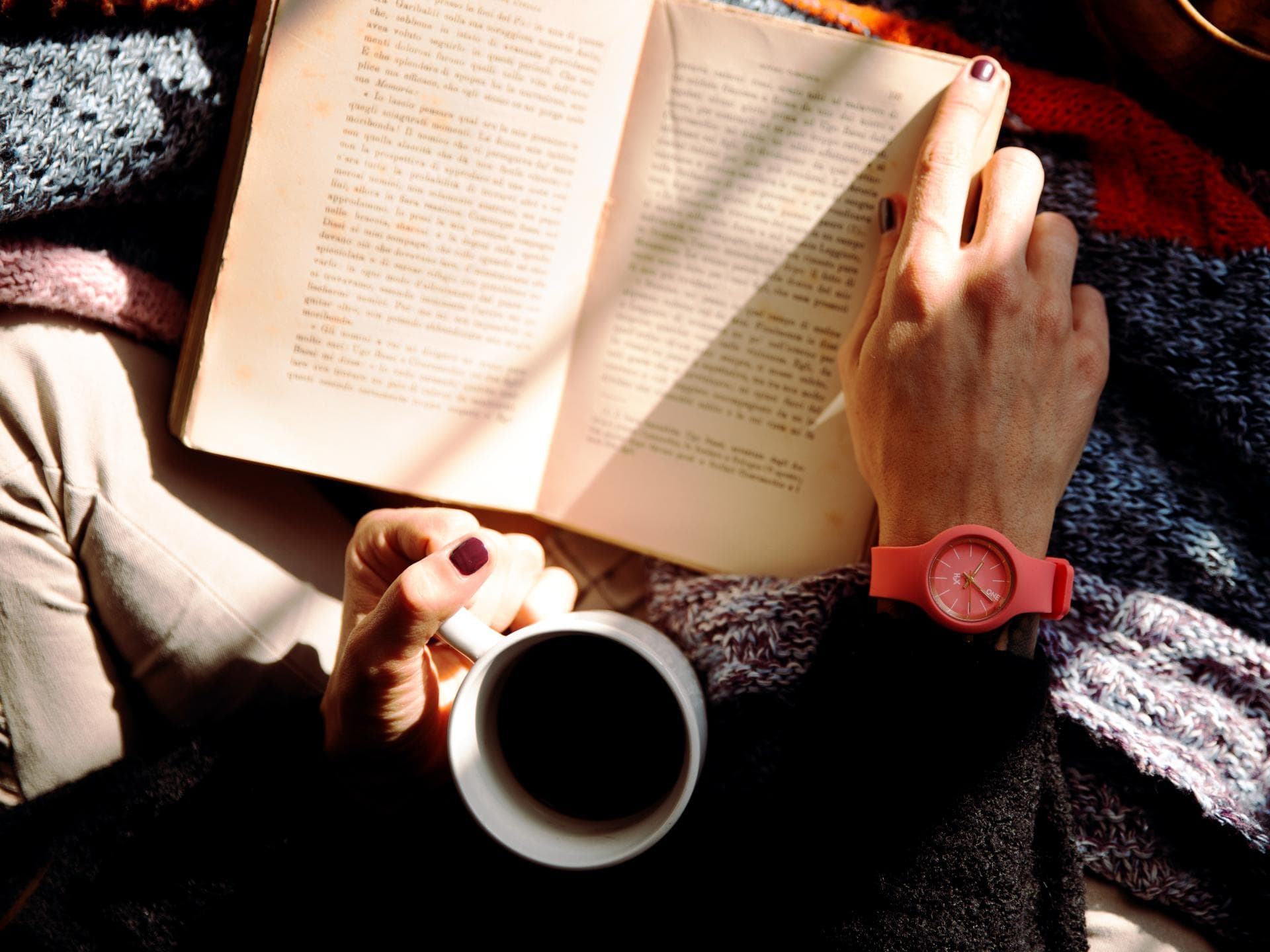 Buch und Kaffee in der Hand
