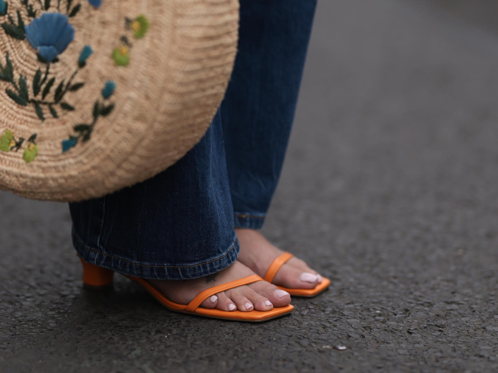 Orange Sandalen und Korbtasche