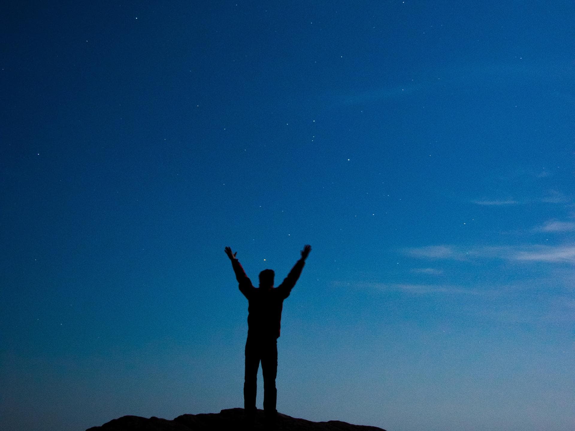 Sternzeichen Erfolg Person vor Sternenhimmel