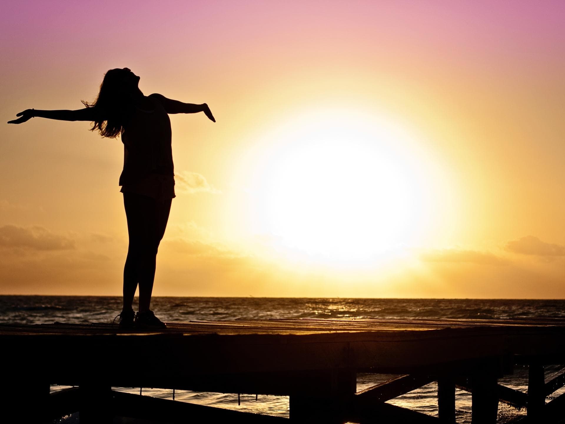 Silhouette einer Frau vor dem Sonnenaufgang